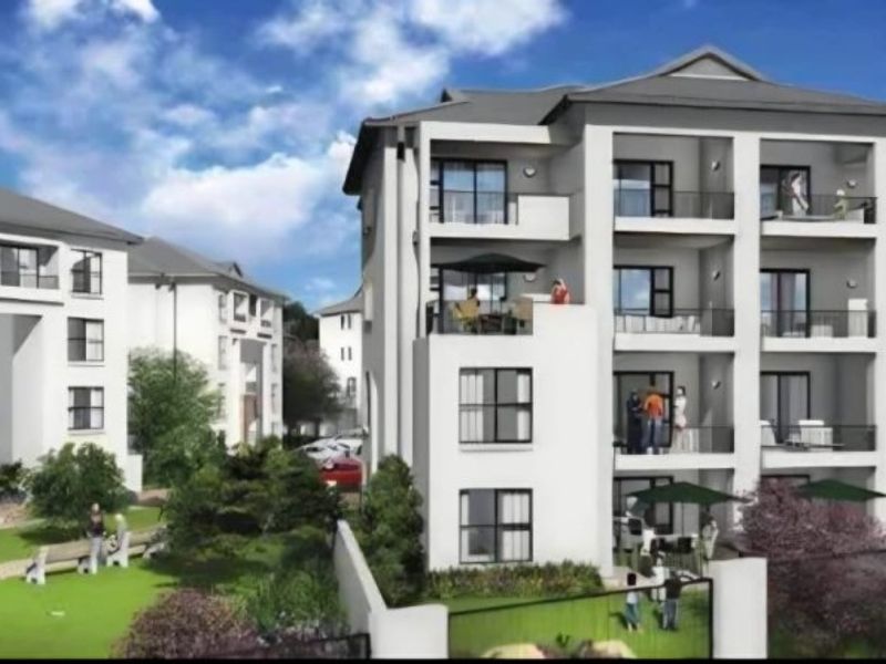 A perspective rendering of a modern apartment complex featuring multi-story buildings with private balconies and landscaped communal garden areas.