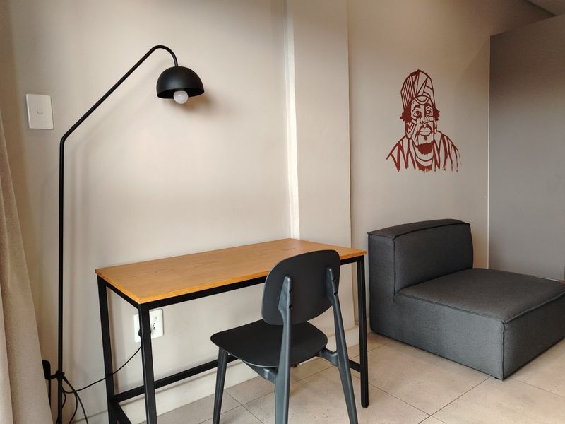 A functional office space featuring tiled flooring and neutral wall finishes, suitable for a home workspace setup.