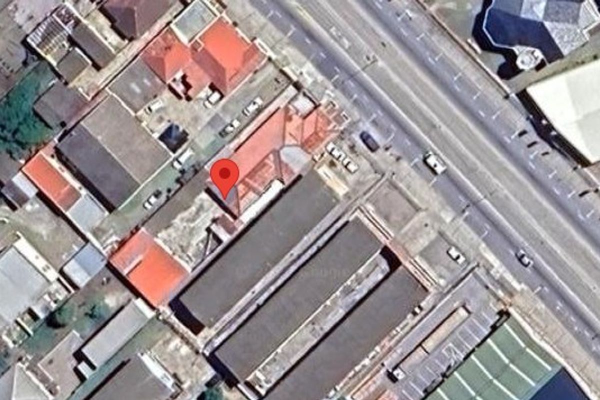 An aerial satellite view showing the property layout, roof structure, and surrounding street access within the neighbourhood.