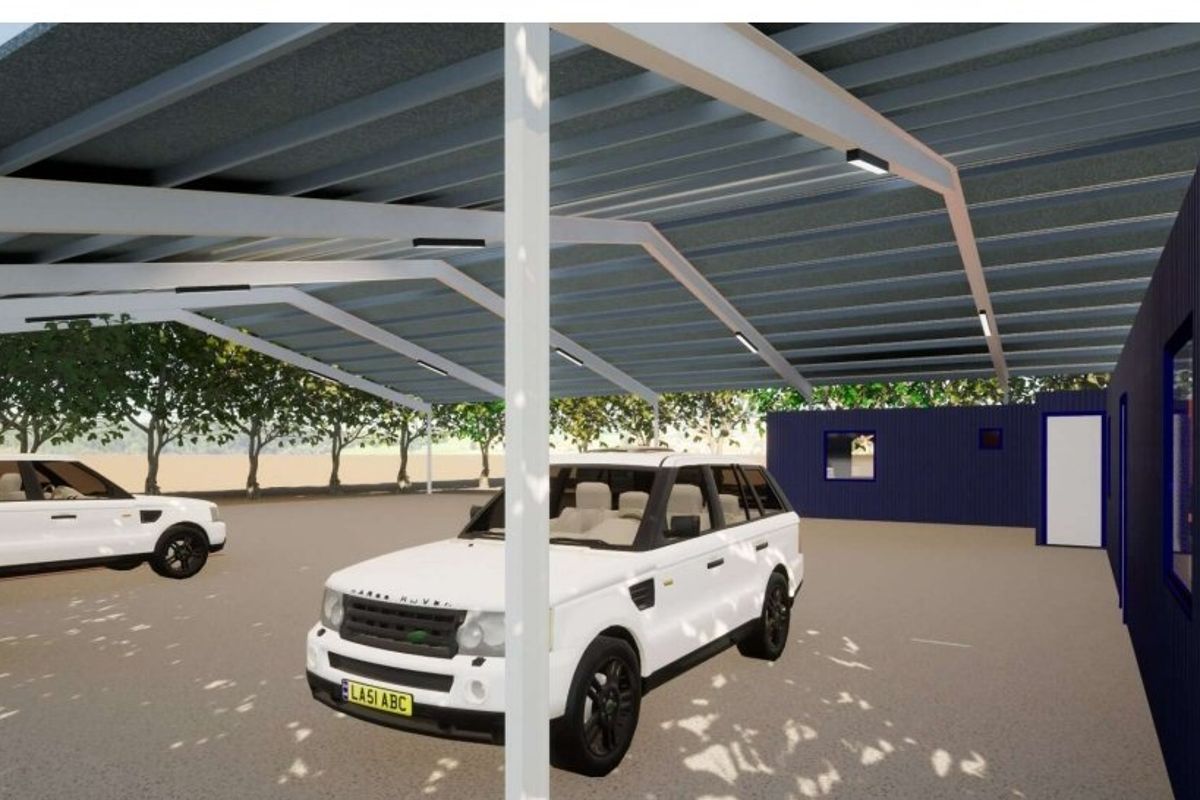 A modern industrial-style carport featuring a steel frame structure with corrugated metal roofing and integrated LED lighting.
