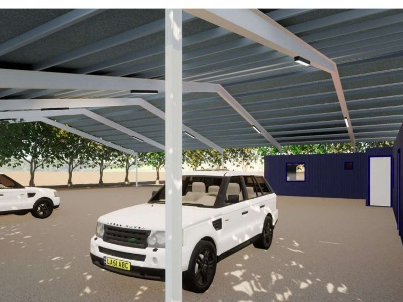 A modern industrial-style carport featuring a steel frame structure with corrugated metal roofing and integrated LED lighting.
