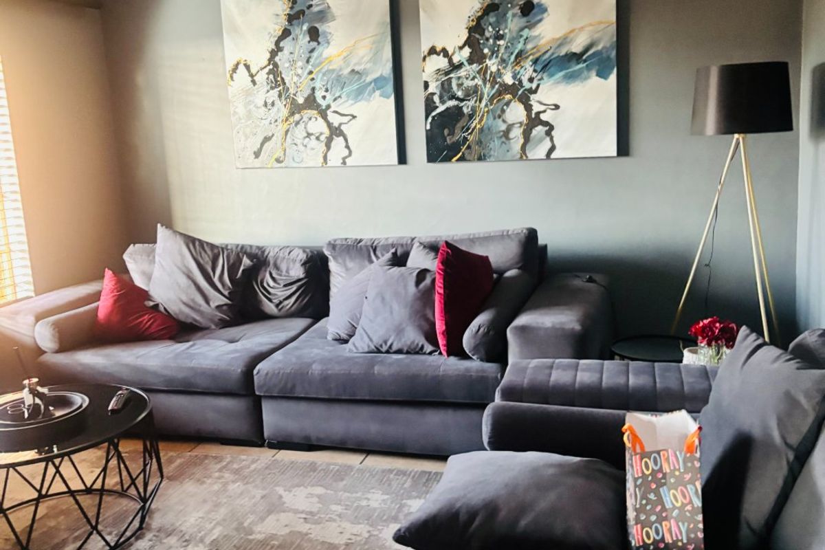 A well-maintained living room featuring recessed downlighting and decorative cove cornicing, creating a comfortable and modern atmosphere.