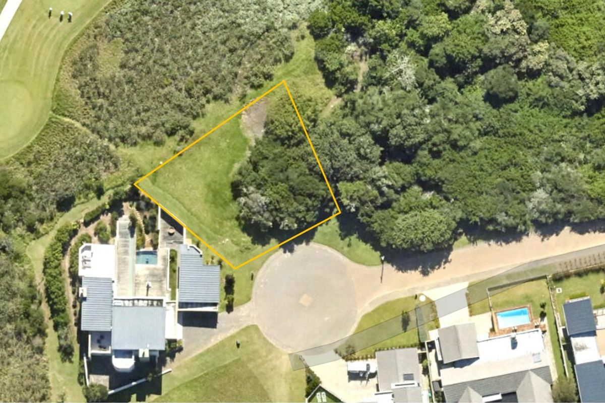 Aerial view of a vacant residential plot situated in a cul-de-sac, featuring established vegetation and proximity to existing residential properties.