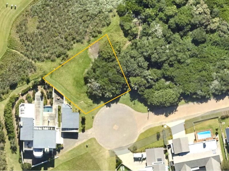 Aerial view of a vacant residential plot situated in a cul-de-sac, featuring established vegetation and proximity to existing residential properties.