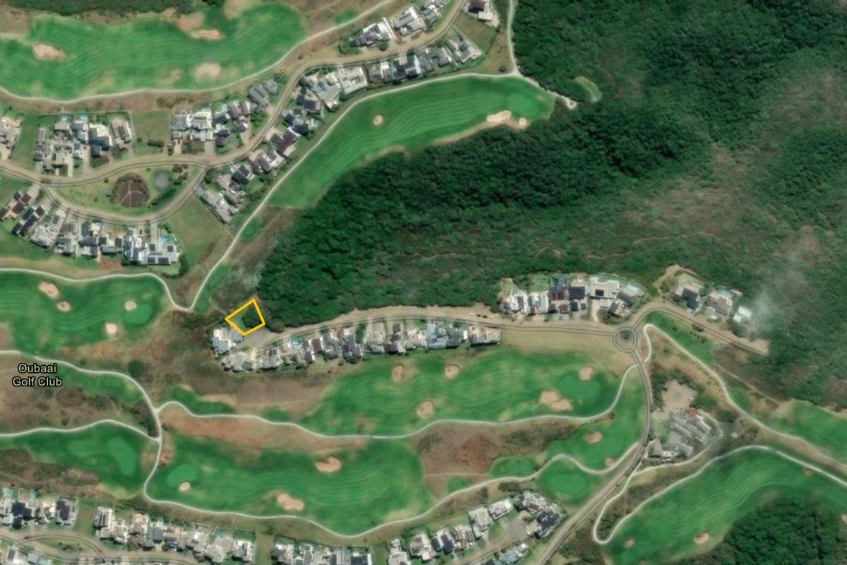 Aerial view of a residential plot located within the Oubaai Golf Club estate, surrounded by lush greenery and established residential properties.