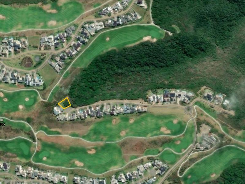 Aerial view of a residential plot located within the Oubaai Golf Club estate, surrounded by lush greenery and established residential properties.