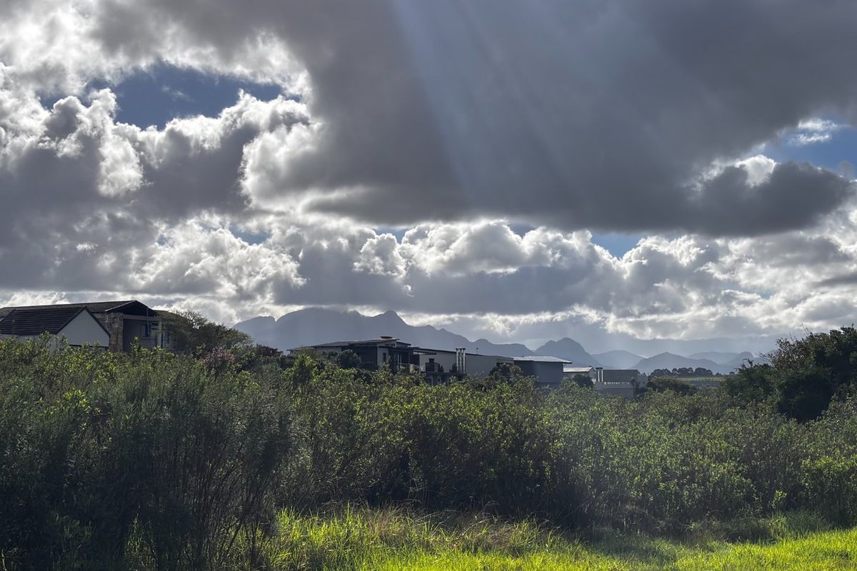A scenic view of the surrounding landscape and distant mountain range, captured from the vacant residential property.