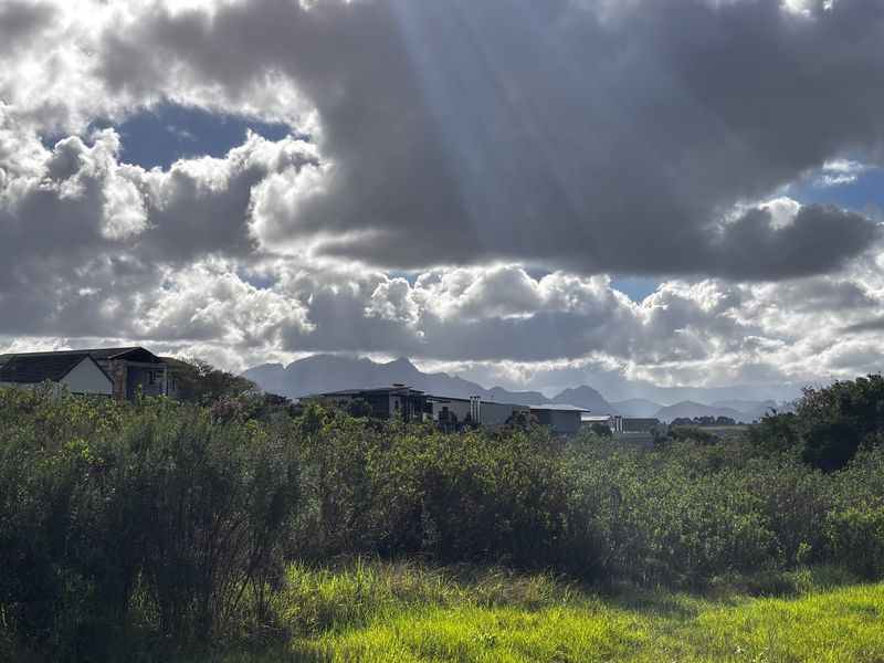 A scenic view of the surrounding landscape and distant mountain range, captured from the vacant residential property.