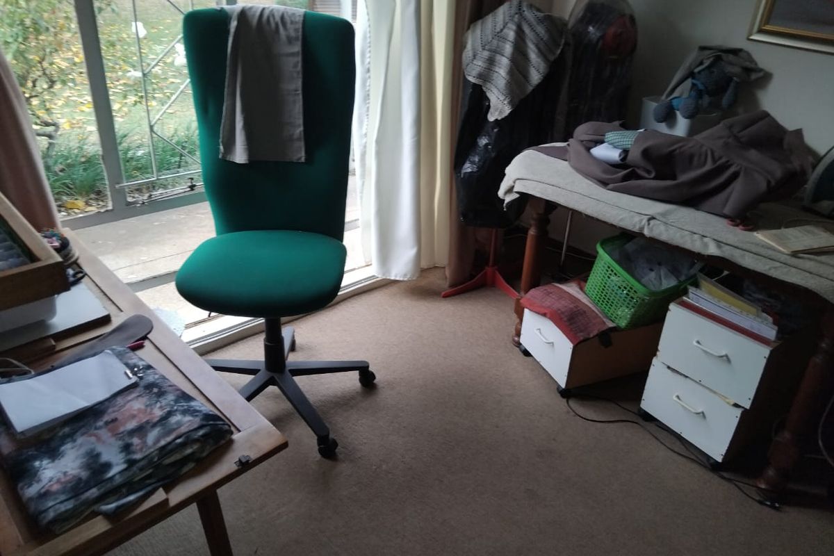 A bedroom space featuring carpet flooring and a sliding glass door providing access to the exterior.