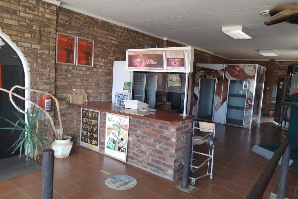 Commercial service area featuring a brick-faced counter, tiled flooring, and functional lighting, suitable for retail or hospitality operations.