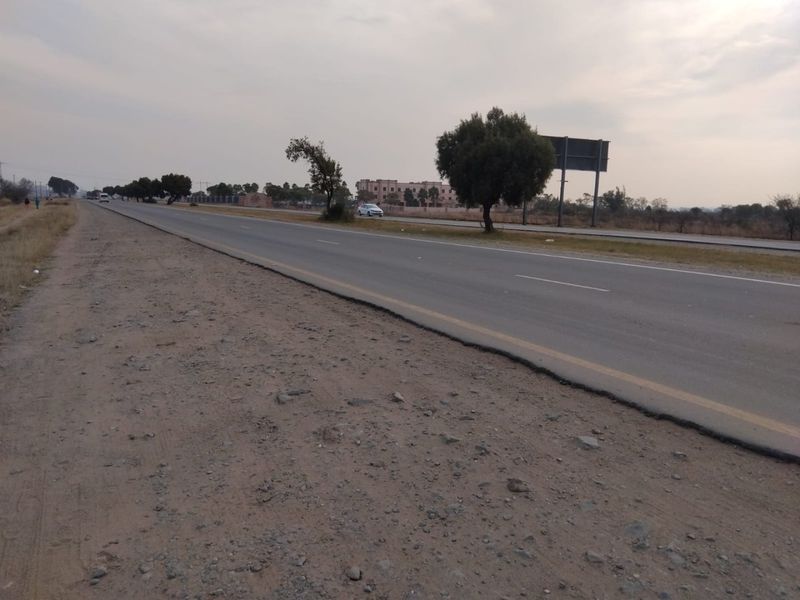 A view of the public road and roadside verge adjacent to the vacant land property.
