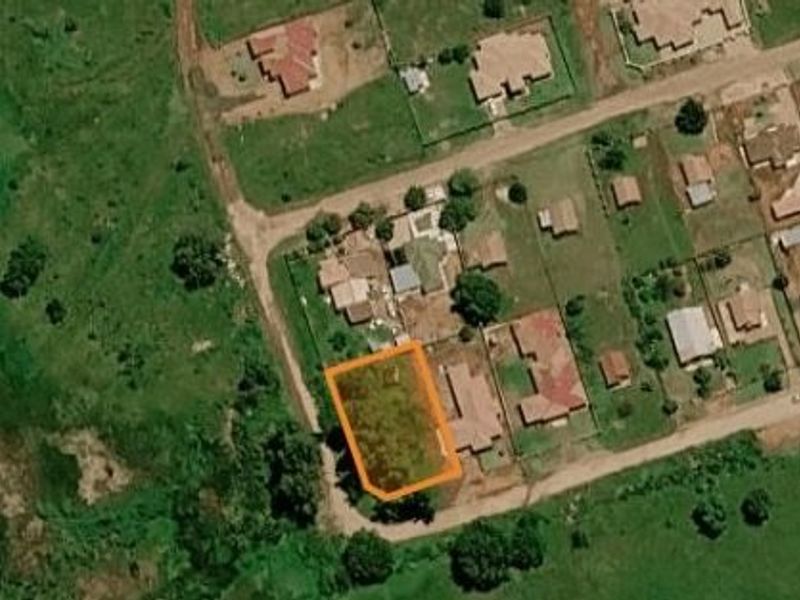 Aerial view of a vacant residential land plot highlighted in orange, situated within an established suburban neighborhood.
