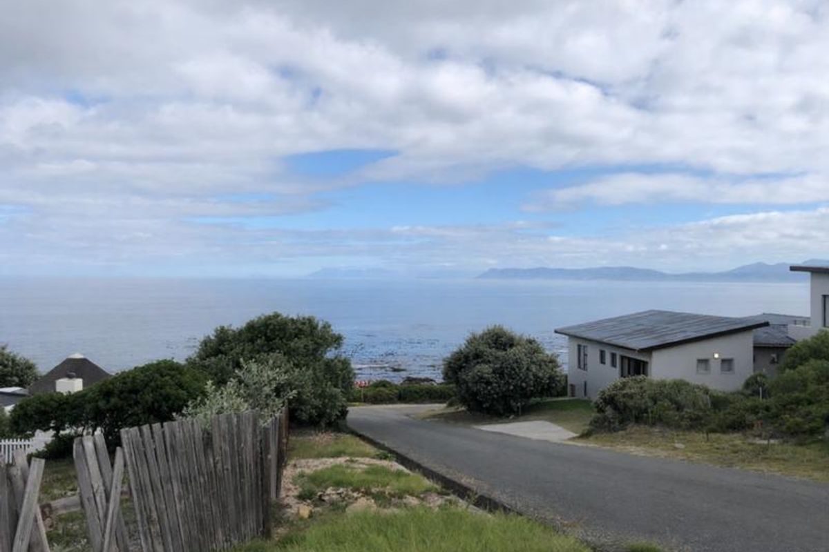 A scenic view overlooking the coastline and ocean, capturing the natural landscape and surrounding residential environment.