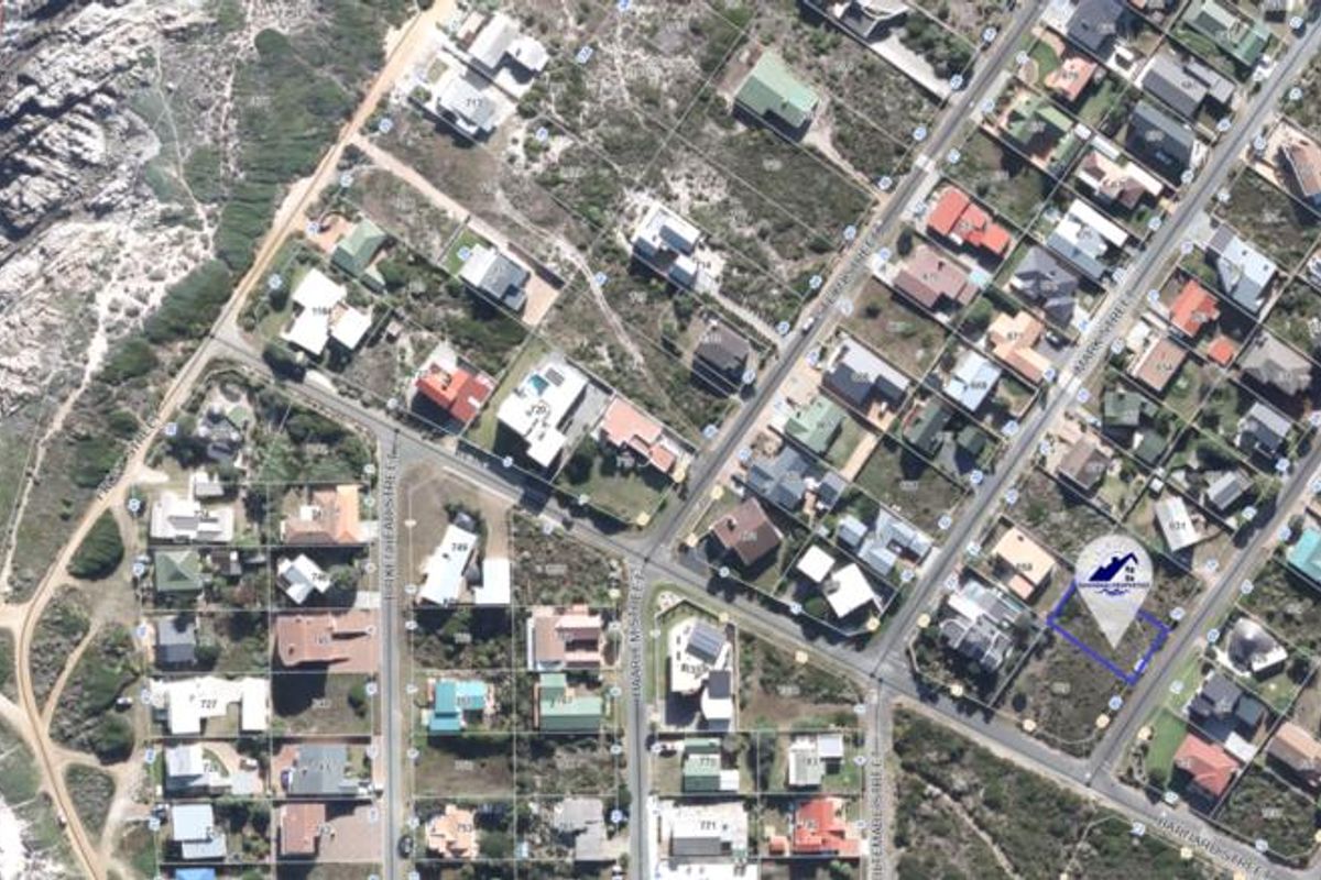 Aerial view of a vacant residential plot located in a coastal neighborhood, highlighting the property boundaries and surrounding street layout.