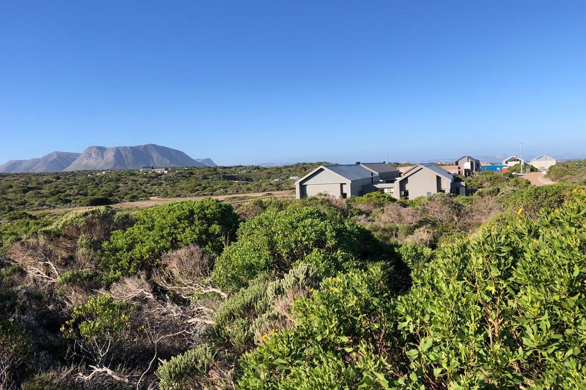 A scenic view of the surrounding natural landscape and mountain range, showcasing the property's tranquil setting and expansive outdoor environment.