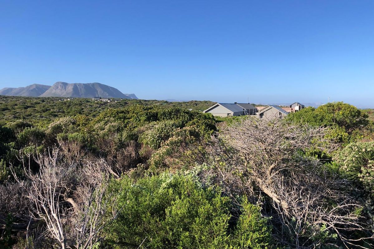 A scenic view of the surrounding natural landscape and distant mountains from the vacant residential property.