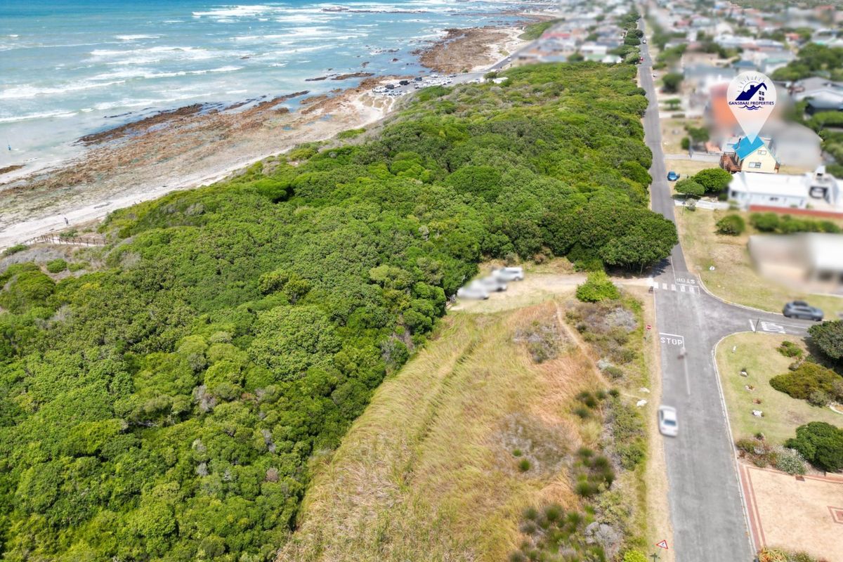 Aerial view of the coastal property location, showcasing proximity to the beach, surrounding vegetation, and local road infrastructure.
