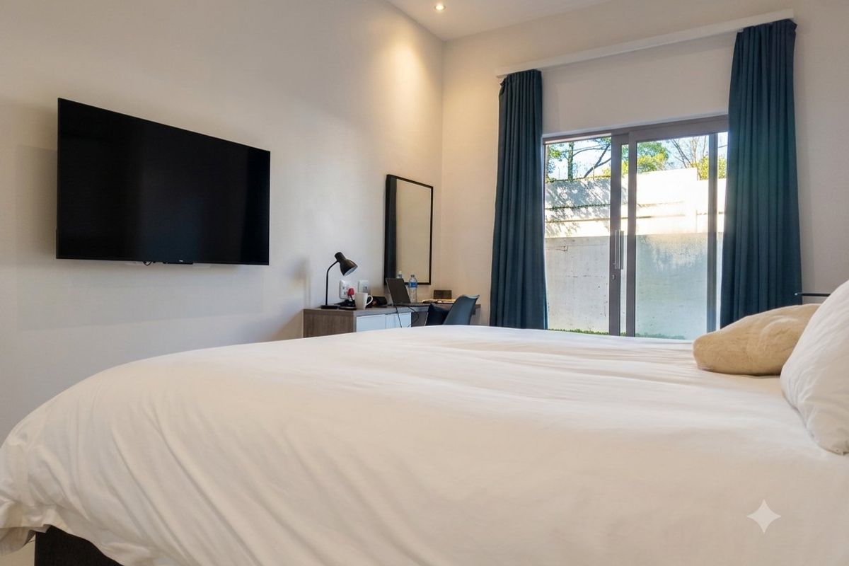 A well-maintained bedroom featuring recessed lighting and a sliding glass door providing direct access to the exterior.