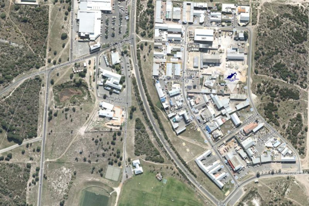 Aerial view of an industrial park showing the layout of various commercial buildings, road infrastructure, and surrounding landscape.