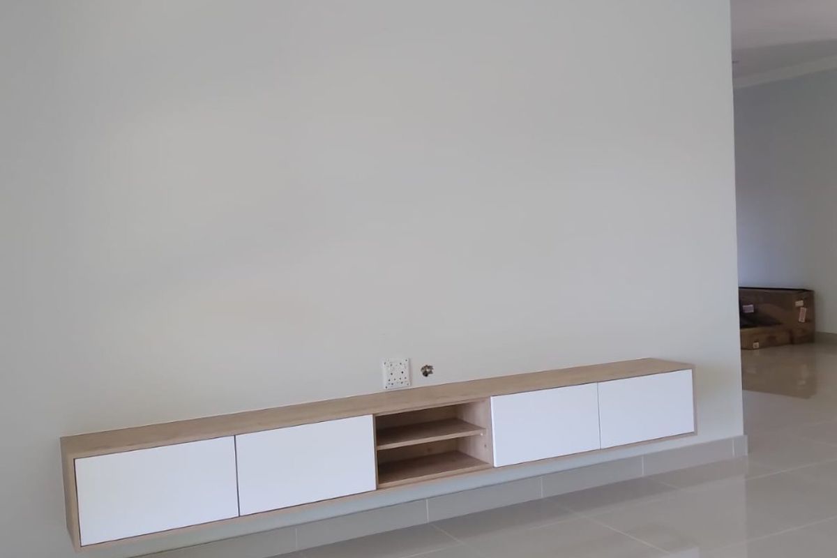 A bright, modern living area featuring sleek white and wood-tone floating cabinetry, polished tiled floors, and clean, neutral wall finishes.