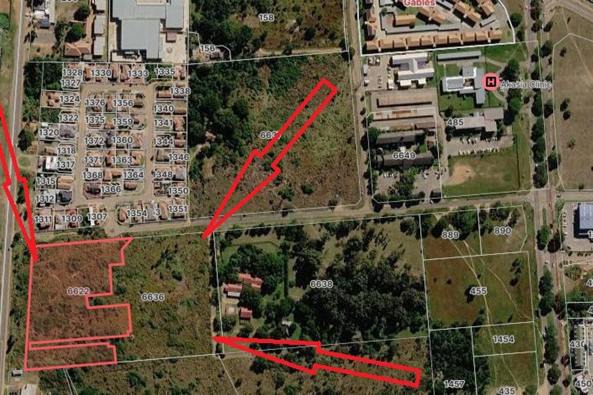 Aerial view of a vacant residential land parcel with red boundary outlines indicating the property location and extent.