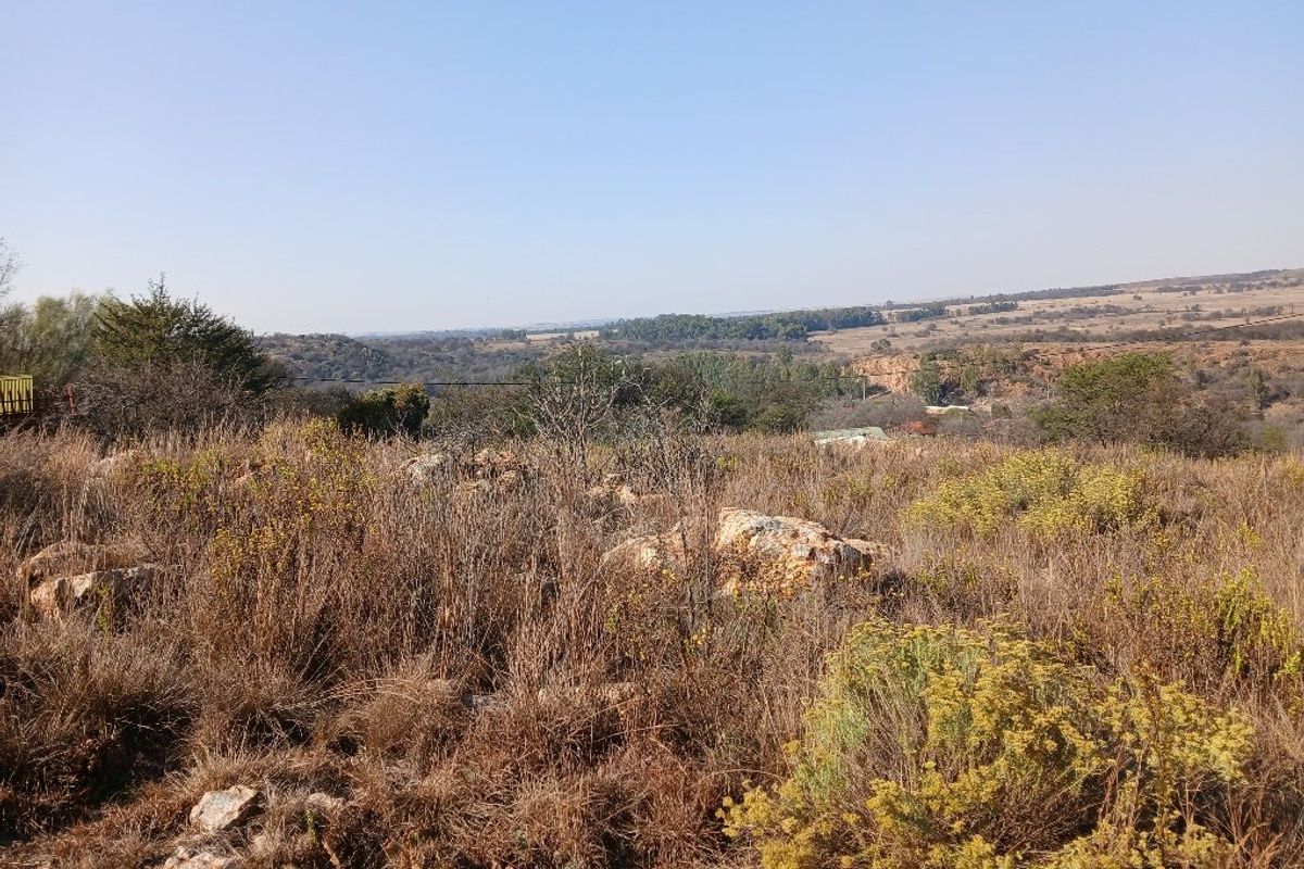 A wide-angle view of the vacant residential land, showcasing the natural landscape, native vegetation, and surrounding terrain.