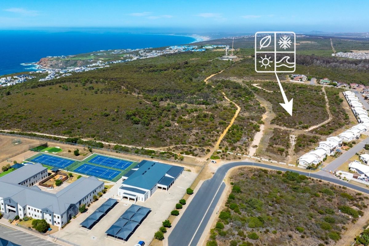 Aerial view of the estate showing surrounding landscape, coastal proximity, and nearby community sports facilities including tennis courts.
