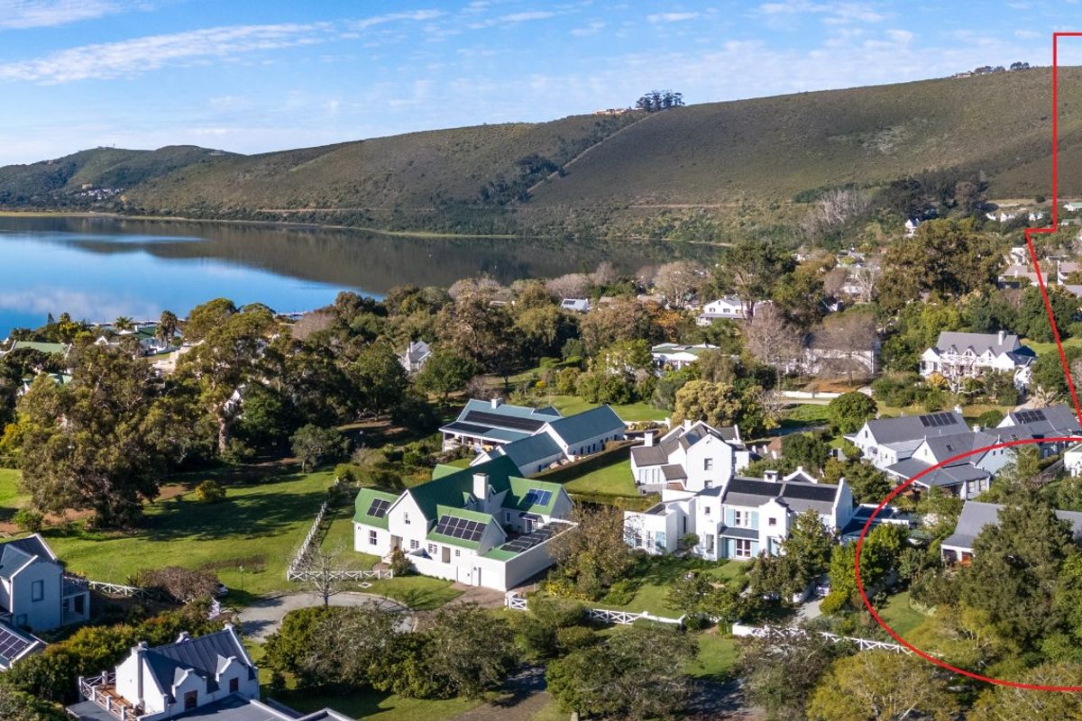 Aerial view of the property location within a scenic coastal estate, highlighting the surrounding landscape, proximity to the lagoon, and neighborhood layout.