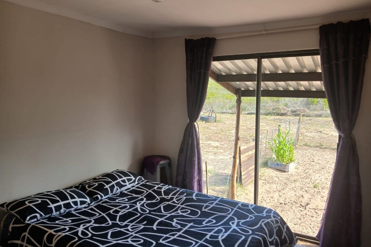 A bedroom featuring a sliding glass door that provides direct access to the outdoor area.