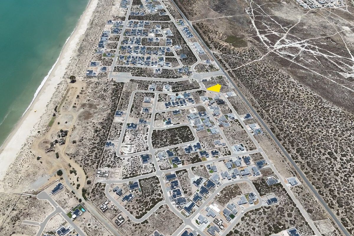 Aerial view of a coastal residential development showing the property location within the established neighborhood near the beach.