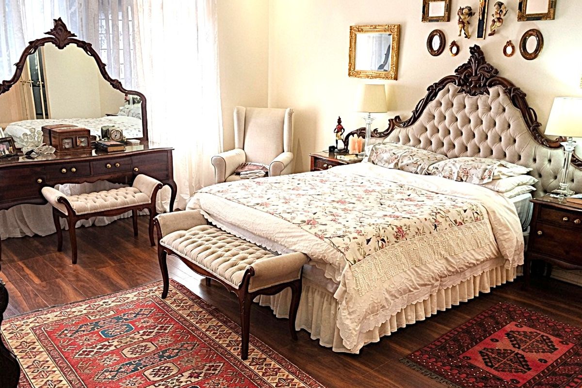 A spacious bedroom featuring warm hardwood flooring and large windows that allow for ample natural light.