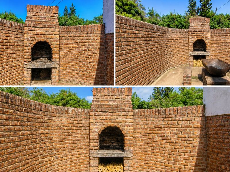 Outdoor entertainment area featuring a traditional built-in brick braai and curved brick boundary walls, providing a rustic space for outdoor cooking and gatherings.