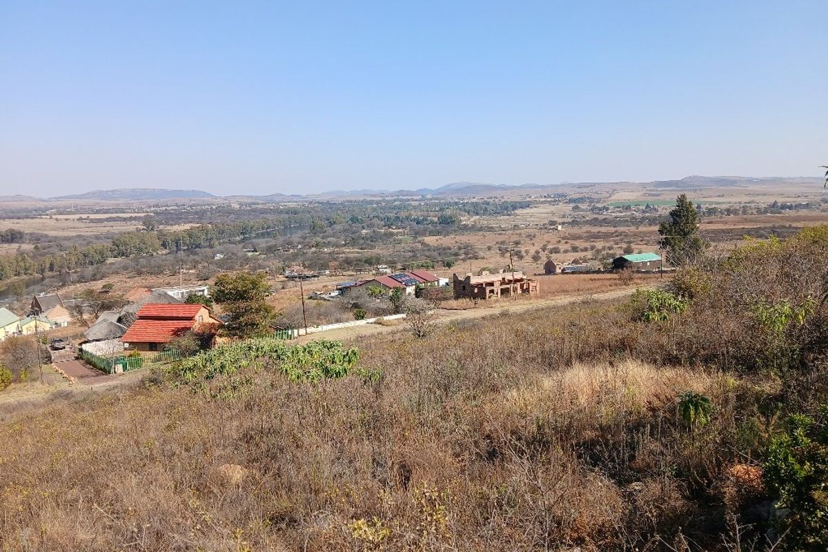 An elevated landscape view overlooking the surrounding rural area, featuring scattered residential properties and natural vegetation.
