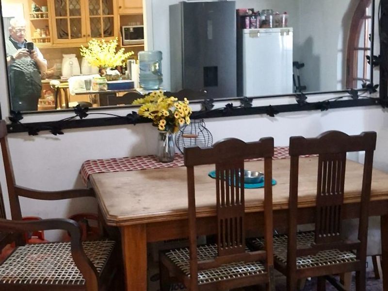 Dining area featuring a pass-through window connecting to the kitchen, providing an open feel between the two spaces.