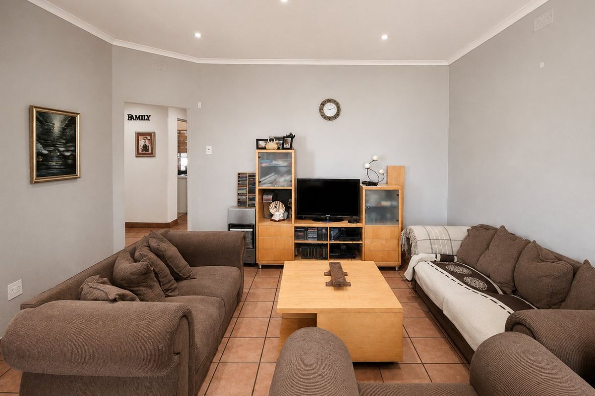 A comfortable living room featuring ceramic tile flooring and recessed downlighting, providing a neutral base for interior design updates.