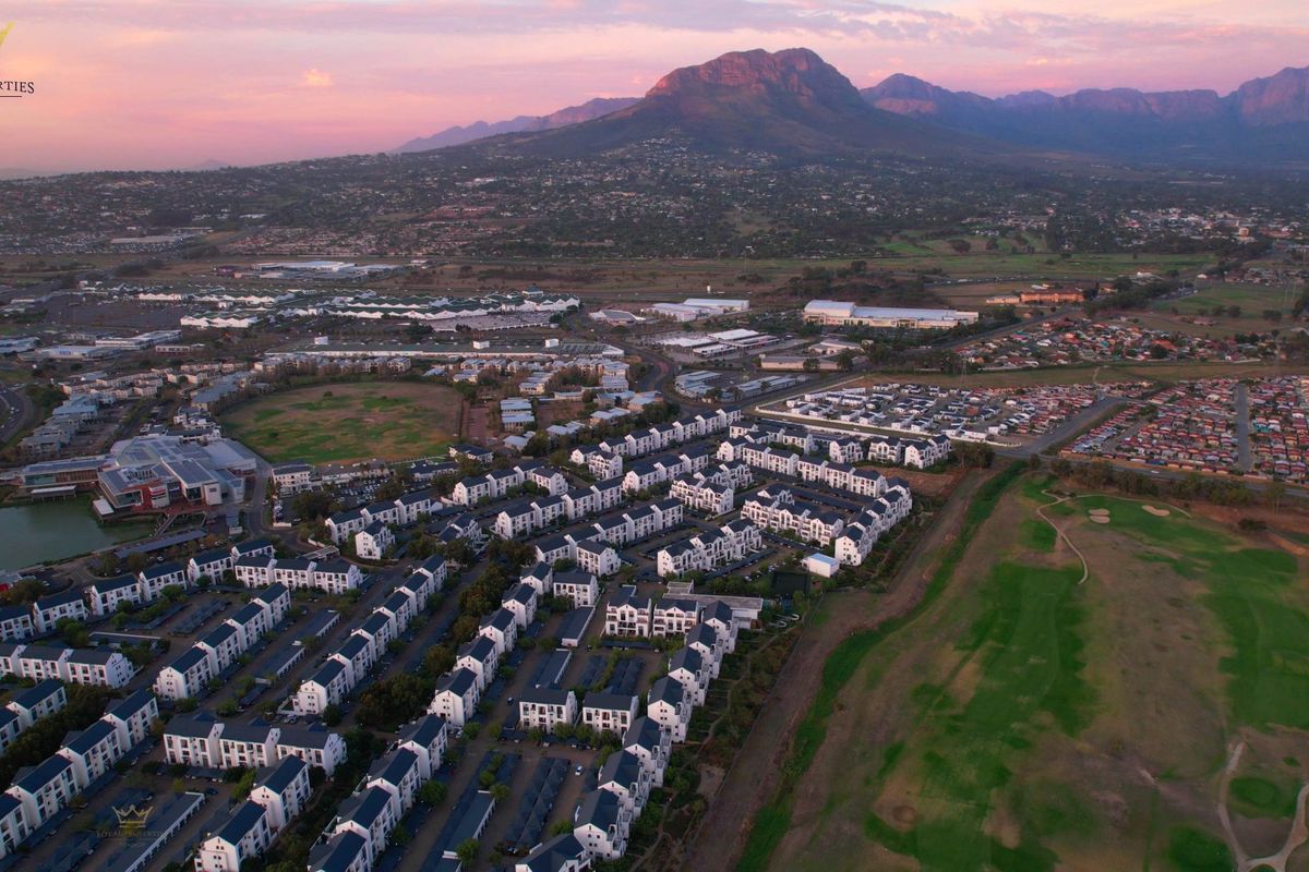 Aerial view of the residential estate and surrounding landscape, showcasing the property's location and proximity to local amenities and mountain views.