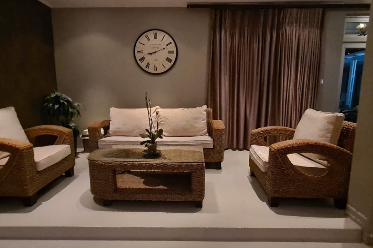 A cozy living room area featuring a raised floor platform and sliding glass doors leading to an outdoor space.