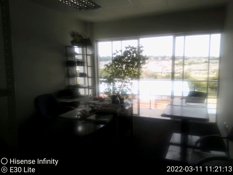 A commercial office space featuring large sliding glass doors that provide natural light and views of the surrounding area.