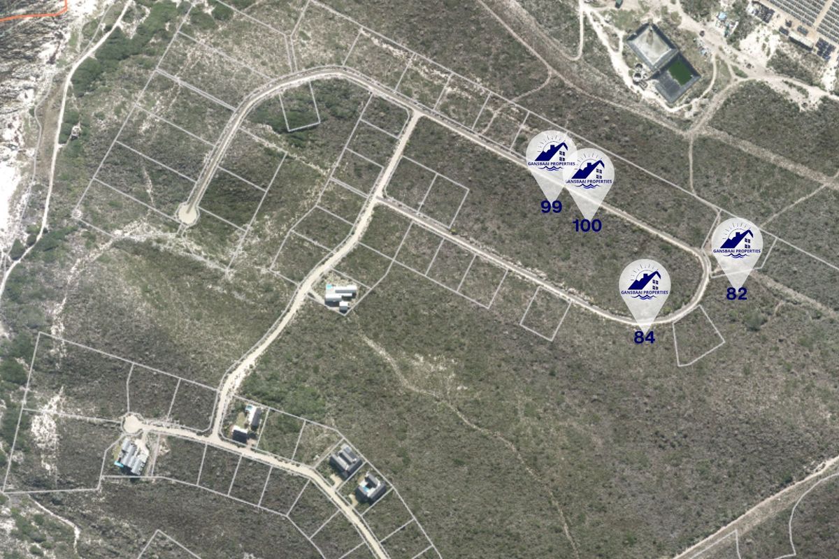 Aerial view of a residential land development showing multiple vacant plots and surrounding coastal landscape.