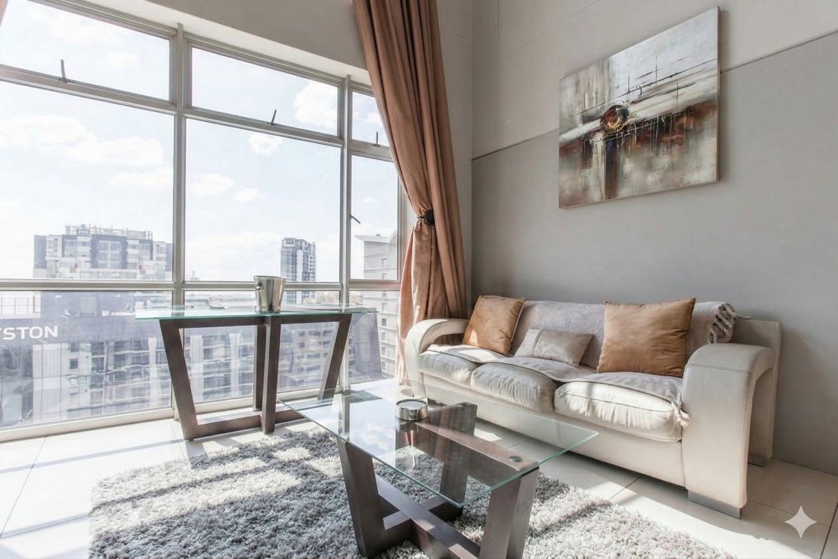 Bright living area featuring expansive floor-to-ceiling windows that provide ample natural light and urban views.