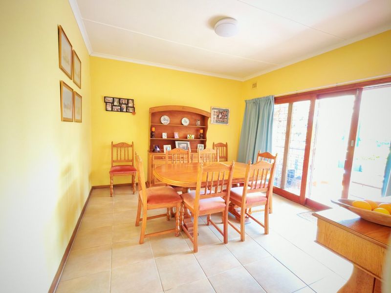 A dining room featuring tiled flooring and sliding glass doors that provide access to the outdoor area.