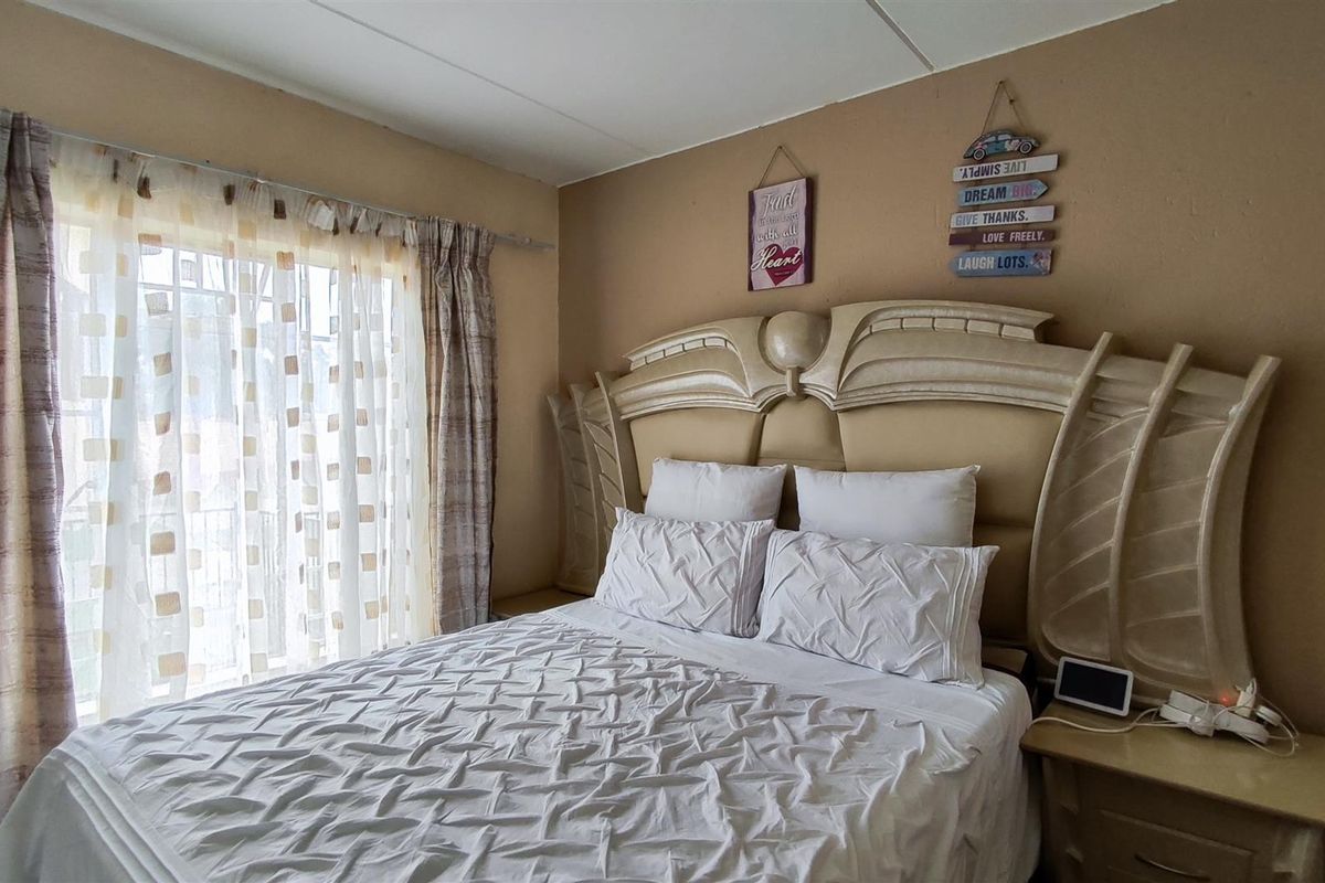 A bedroom featuring a sliding glass door providing natural light and access to an outdoor area.