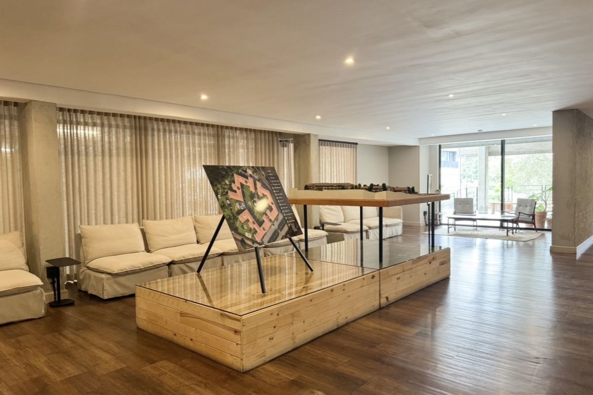 Spacious living area featuring timber flooring, recessed lighting, and large sliding glass doors leading to an outdoor space.