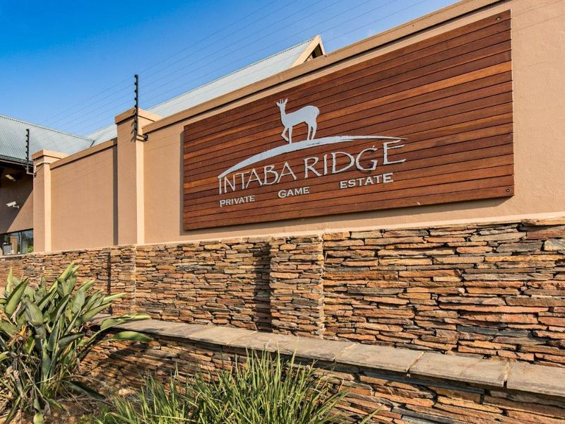 Entrance signage for Intaba Ridge Private Game Estate featuring stone cladding and timber detailing.