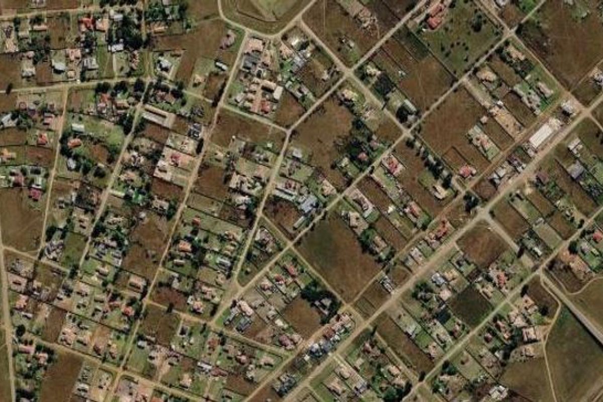 An aerial view of a residential neighborhood showing the layout of streets and individual property plots.