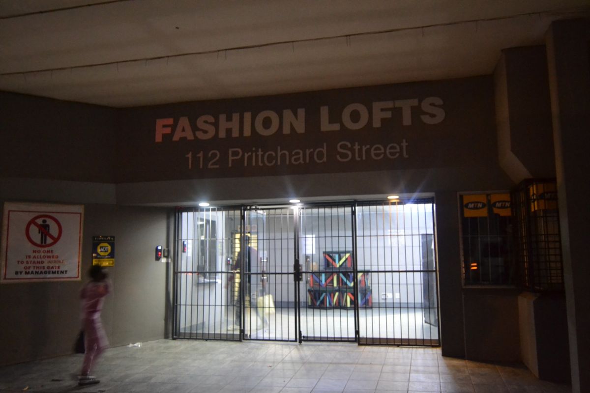 The entrance to Fashion Lofts at 112 Pritchard Street, featuring a secure gated access point and building signage.