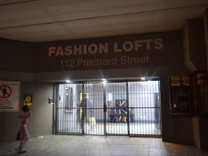 The entrance to Fashion Lofts at 112 Pritchard Street, featuring a secure gated access point and building signage.