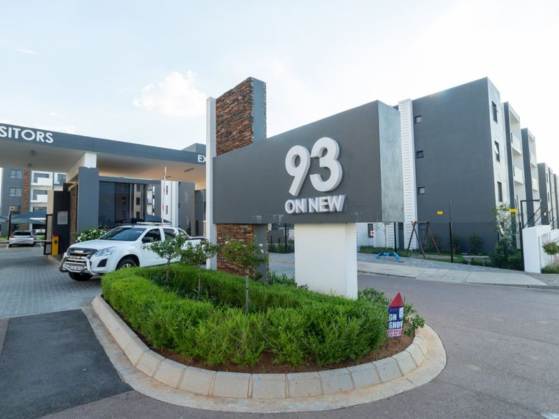 The entrance to 93 On New apartment complex, featuring modern signage, a secure gatehouse, and well-maintained landscaped grounds.