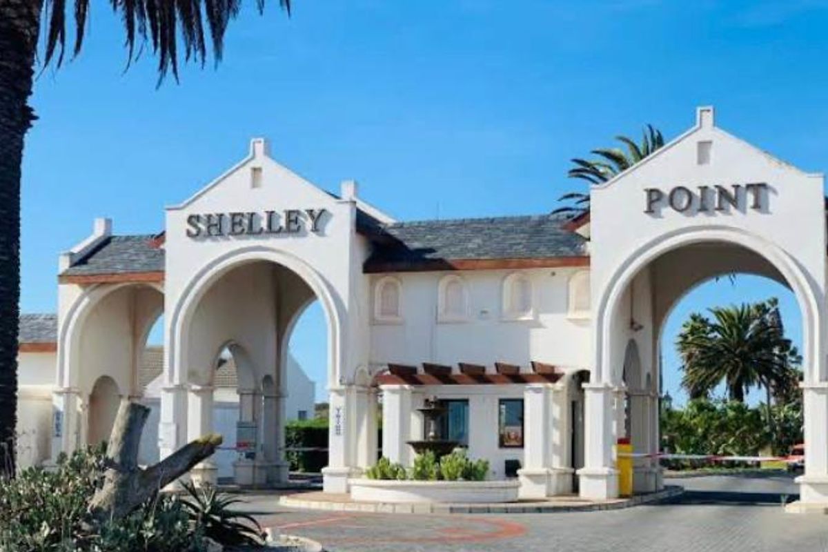 The main entrance gate to Shelley Point estate, featuring architectural archways, security access control, and a central fountain.