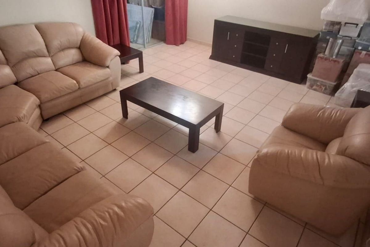 A living room featuring ceramic tile flooring and neutral wall finishes, providing a functional space for relaxation.